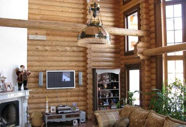 This interior of a wooden log home combines modernity and classic, cozy and comfortable inside