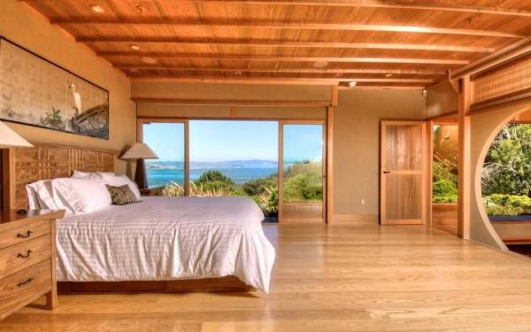 Bedroom in a wooden house with elements of oriental style