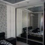 Built-in bedroom closet with solid mirrored doors