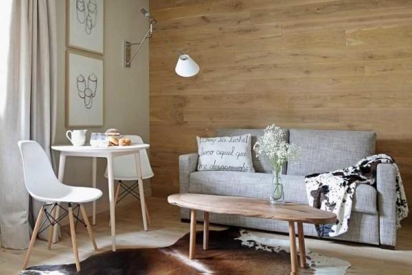 One wall is finished with wood or stone - one of the recent fashion trends