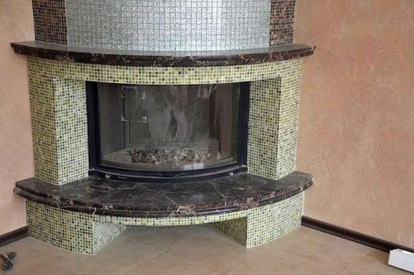 Fireplace mosaic finishing is especially good on rounded shapes, where other materials are very problematic to use