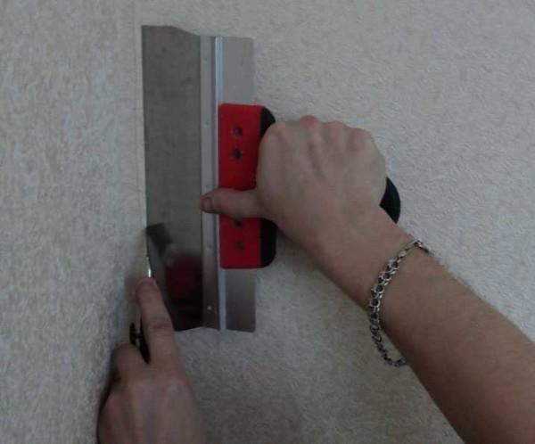 Cutting the wallpaper in the corner