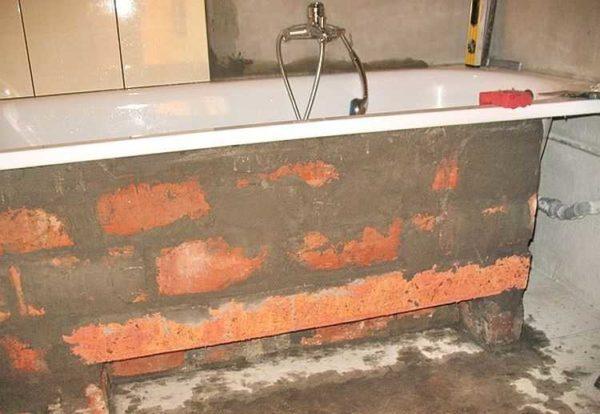 Brick screen under the bathtub ready for tiling