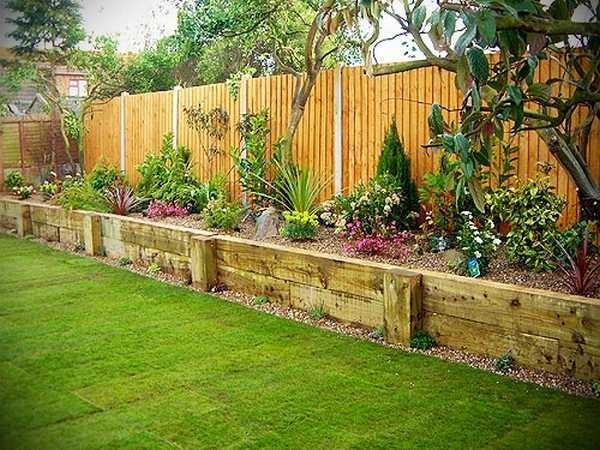 A tall flowerbed with a board fence. The construction is inexpensive and the look is solid