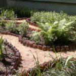 Carefully made fence for flowerbeds from plastic bottles