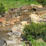 How to dam a pond if you have a natural stream on your property - dig a pit, cover it with a stone and direct the stream into it