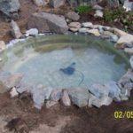 The next stage of making a mini-pond for summer cottage is decorating the edges with stones