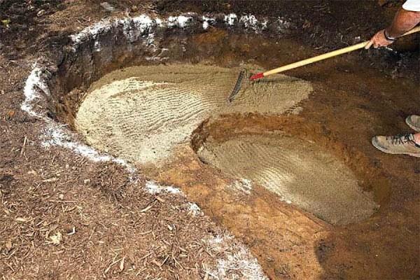 The sand is first leveled with a rake