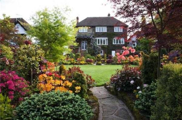 Lush vegetation interspersed with manicured lawns are signs of an English garden