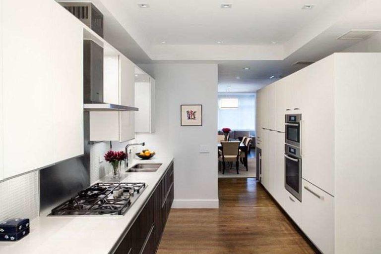 Kitchen in black and white color: white furniture, black wall and appliances