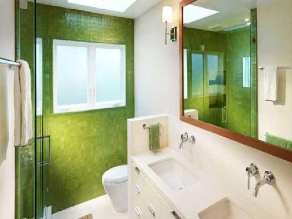 A green mosaic wall in a small bathroom refreshes the decor