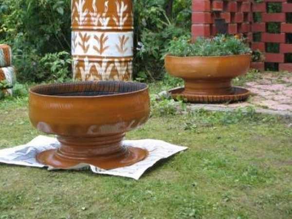 A flower vase made from an old car tire 