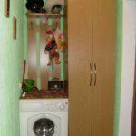 The photo shows the option of installing a washing machine in a narrow hallway