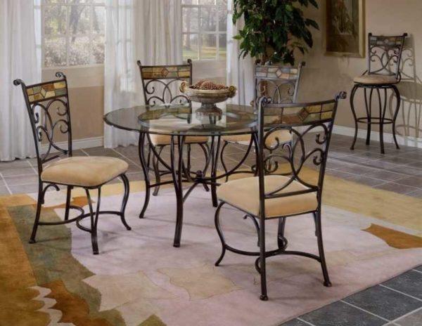 Glass tables with wrought iron legs and chairs in the same style