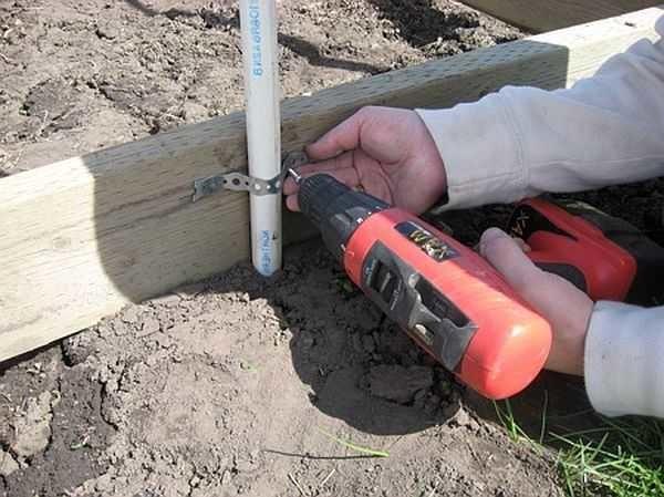 The pipe is fastened to the base beam with a perforated metal strip